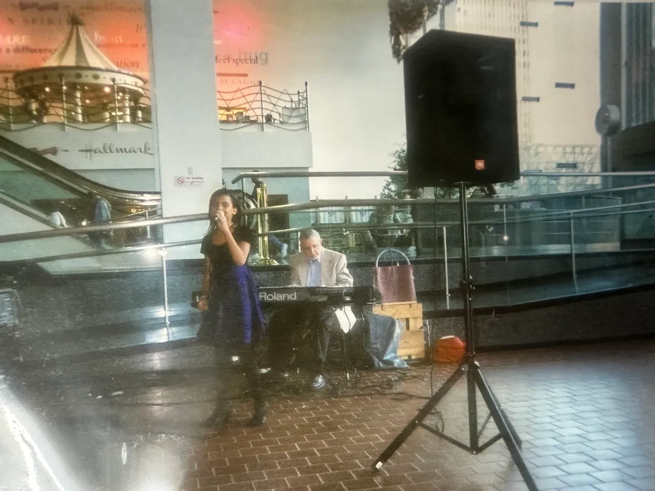 Chloe McFadden performing at a Hallmark venue with a pianist