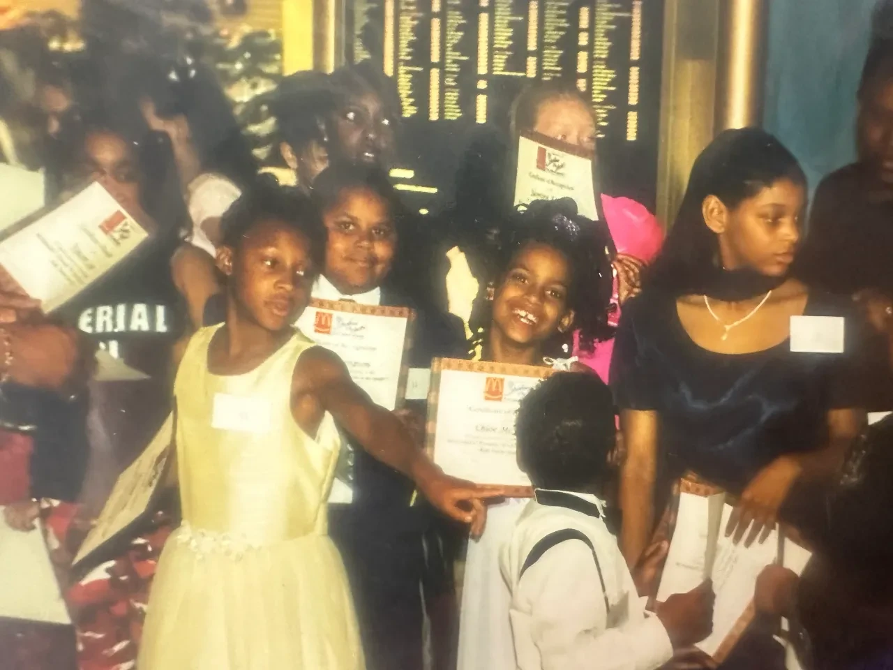 Young Chloe McFadden holding a certificate at a talent competition